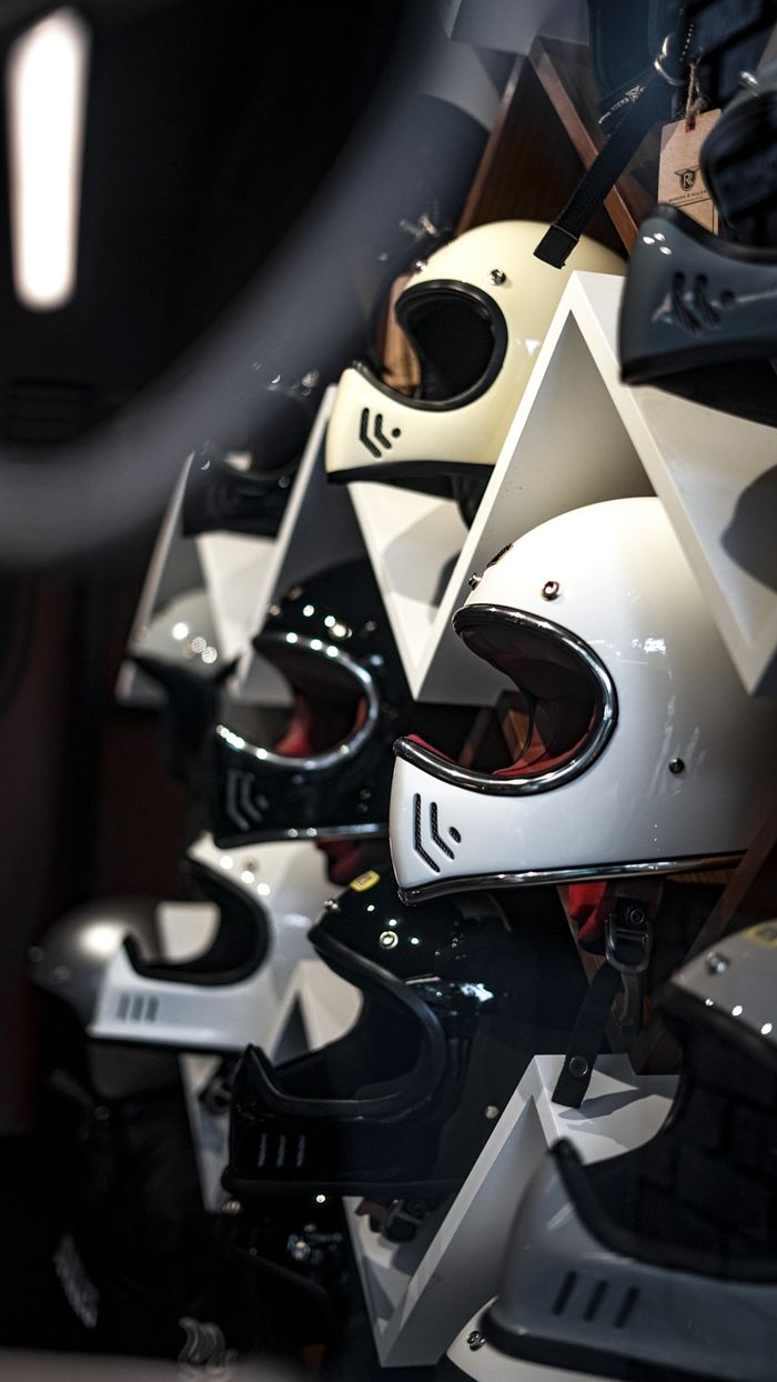 about-02 Vertical shot of various helmets on display in a store, suitable for business and shopping themes.